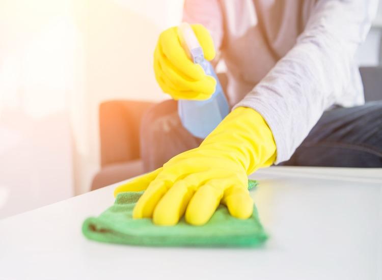 people-housework-housekeeping-concept-close-up-man-hands-cleaning-table-with-cloth-detergent-spray-home